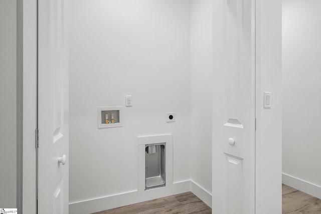 laundry room with hookup for a washing machine, light wood-style flooring, laundry area, baseboards, and electric dryer hookup