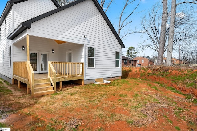 rear view of house featuring crawl space, a wooden deck, and french doors