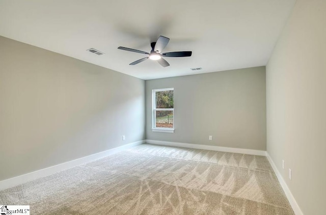 unfurnished room with light carpet, baseboards, and visible vents