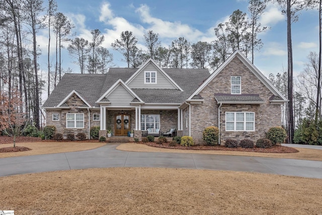 craftsman house with french doors and roof with shingles