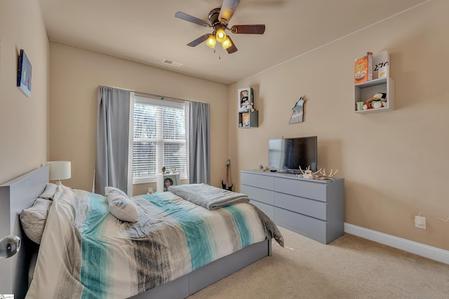 bedroom with baseboards, visible vents, a ceiling fan, and light colored carpet