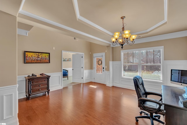 office featuring wood finished floors, a raised ceiling, visible vents, and a notable chandelier