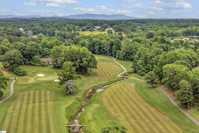 aerial view with view of golf course and a mountain view