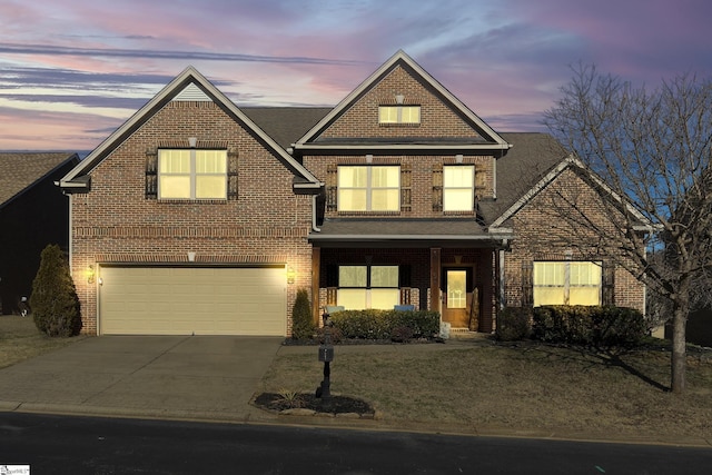 traditional home with a garage, concrete driveway, and brick siding