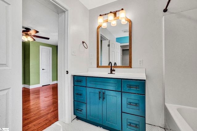 full bath featuring ceiling fan, baseboards, wood finished floors, and vanity