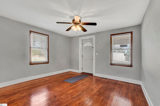 entrance foyer with visible vents, ceiling fan, baseboards, and wood finished floors