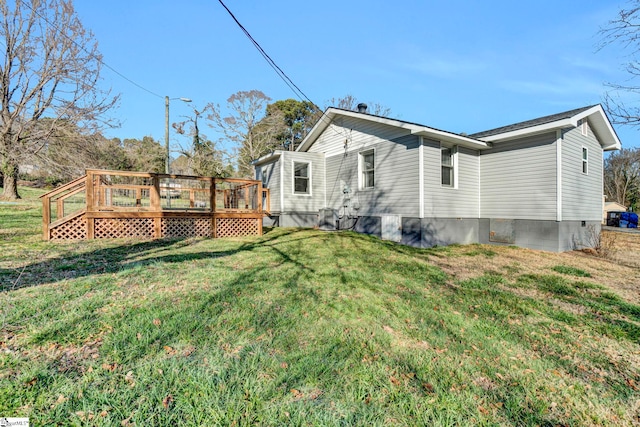 view of property exterior featuring crawl space, a yard, and a deck