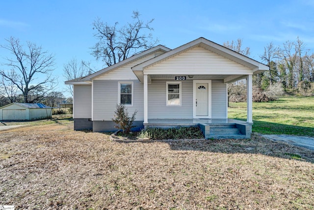 bungalow featuring a porch and a front yard