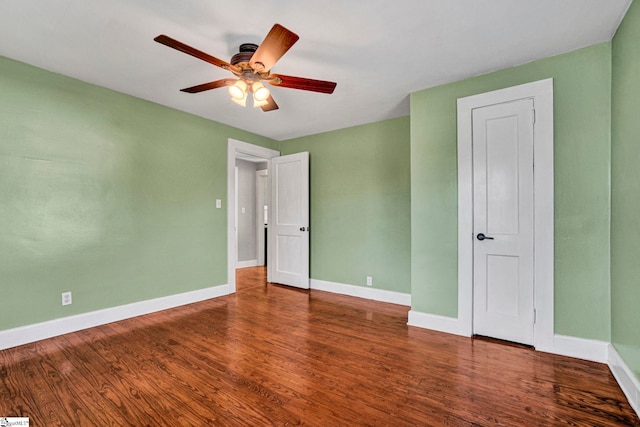 unfurnished bedroom with a ceiling fan, baseboards, and wood finished floors