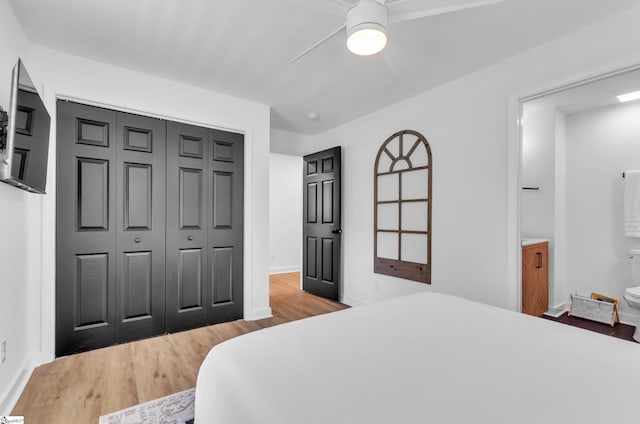 bedroom featuring a closet, baseboards, ceiling fan, and light wood finished floors