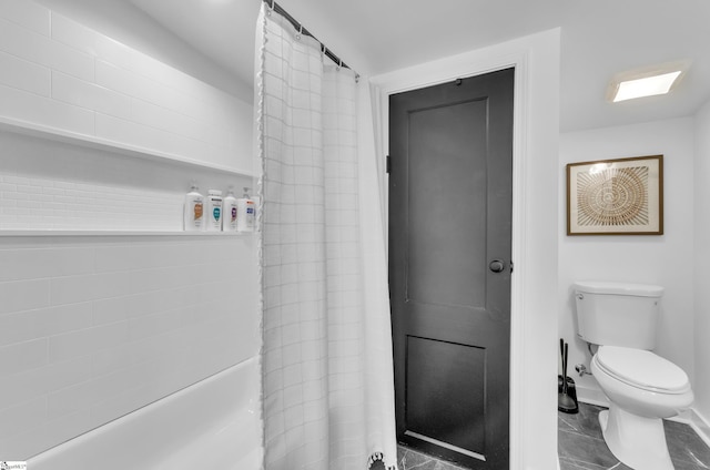 bathroom featuring baseboards and toilet