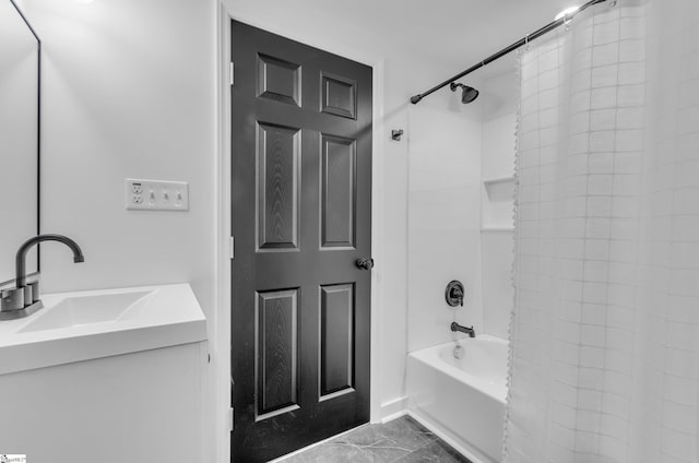 bathroom with marble finish floor, vanity, and shower / bath combo with shower curtain