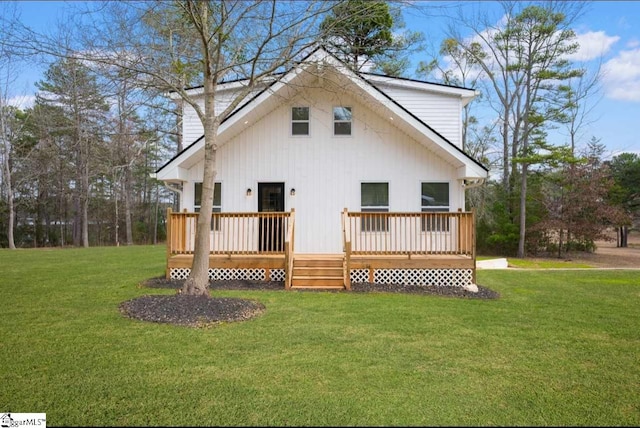 rear view of property featuring a yard, a chimney, and a wooden deck