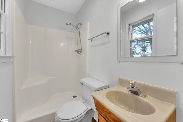 bathroom with toilet, a shower, and vanity