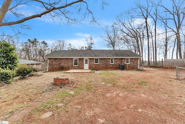 rear view of house with a patio, brick siding, cooling unit, and fence