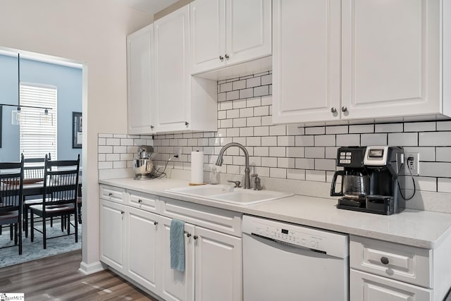 kitchen featuring dark wood-style flooring, white cabinets, dishwasher, and a sink