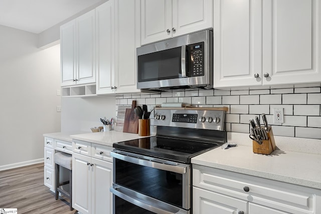 kitchen with appliances with stainless steel finishes and white cabinets