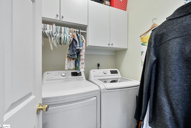 laundry room featuring cabinet space and washer and dryer