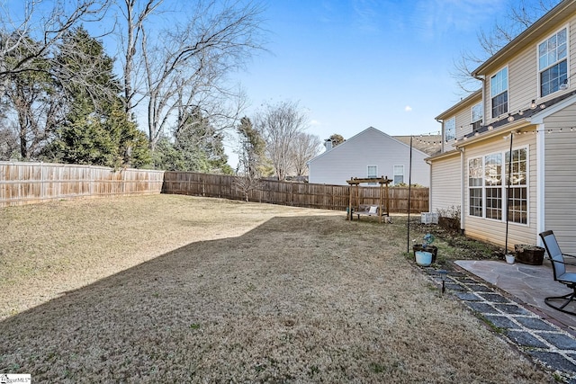 view of yard with a fenced backyard and a patio