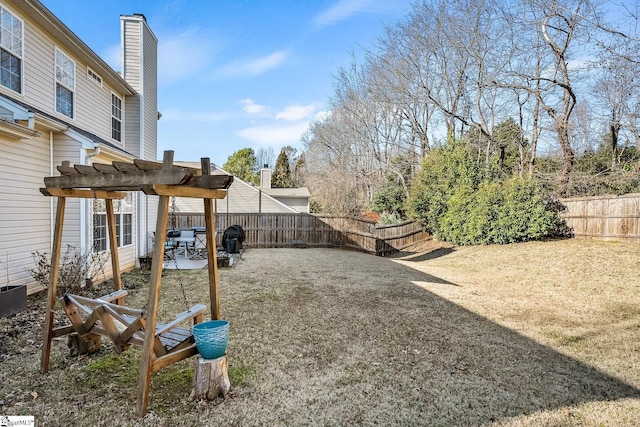 view of yard with a fenced backyard, a pergola, and a patio