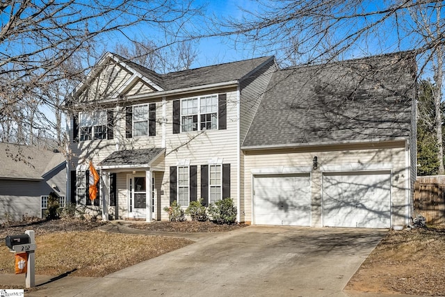 colonial-style house featuring a garage, concrete driveway, and a shingled roof