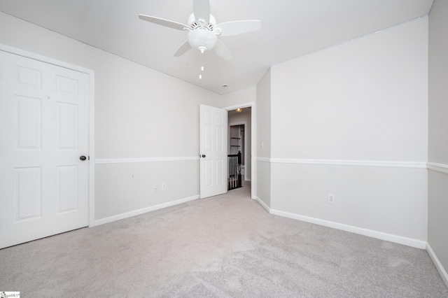 unfurnished bedroom featuring light carpet, ceiling fan, and baseboards