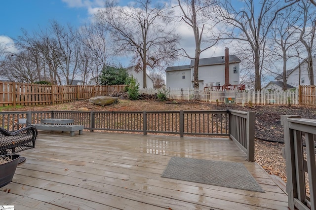 wooden deck featuring a fenced backyard and a hot tub