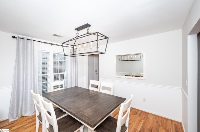 dining room with an inviting chandelier and wood finished floors