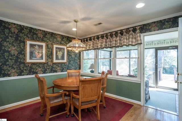 dining space with wood finished floors, visible vents, baseboards, and wallpapered walls