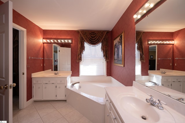 full bathroom featuring a garden tub, tile patterned floors, two vanities, a sink, and wallpapered walls