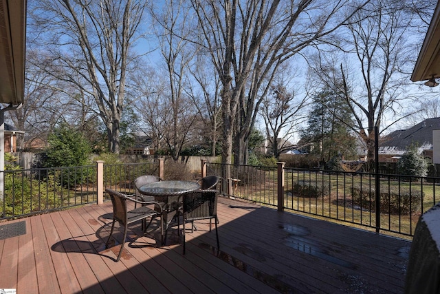 deck with outdoor dining space and a fenced backyard