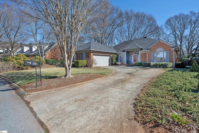 ranch-style house with concrete driveway, brick siding, a front lawn, and an attached garage