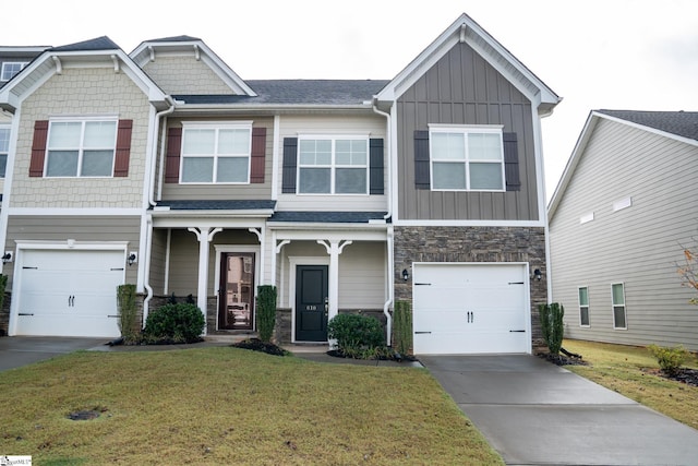 craftsman inspired home with an attached garage, stone siding, driveway, board and batten siding, and a front yard