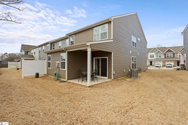 back of property featuring central air condition unit, a patio area, a residential view, and fence