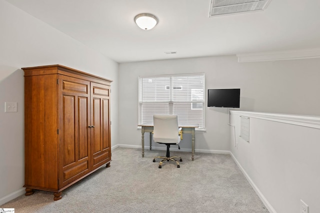 office space featuring baseboards, visible vents, and light colored carpet