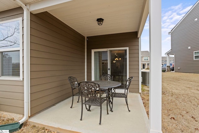 view of patio / terrace with outdoor dining space and central air condition unit