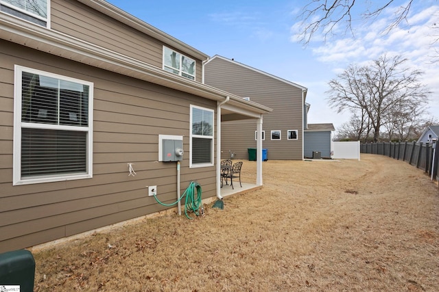 rear view of property with fence and a patio