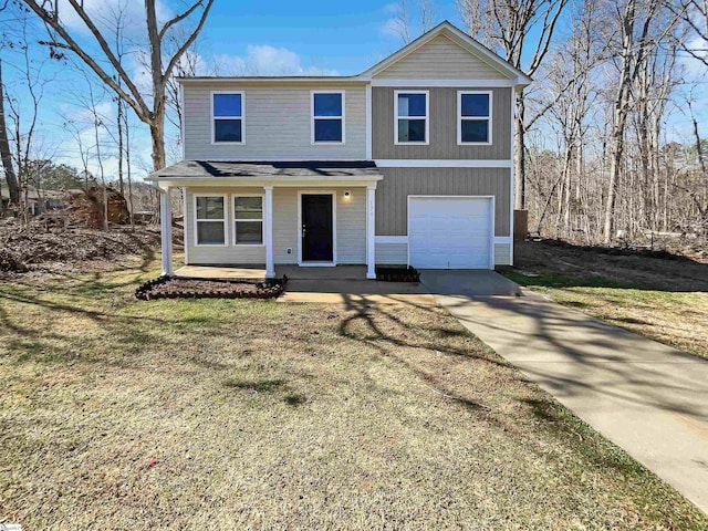 traditional home featuring a front yard, covered porch, an attached garage, and concrete driveway