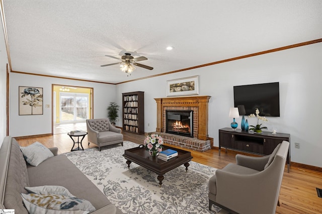 living area with light wood finished floors, baseboards, a brick fireplace, and ornamental molding