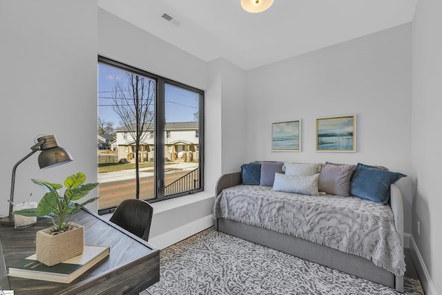 bedroom featuring visible vents and baseboards