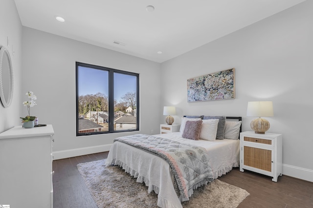 bedroom with dark wood-style flooring, recessed lighting, visible vents, and baseboards