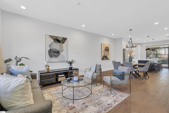 living room with baseboards, wood finished floors, and recessed lighting