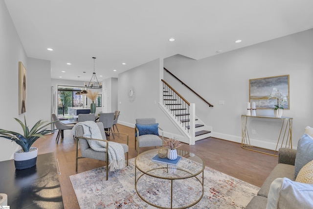 living room featuring stairs, wood finished floors, and recessed lighting