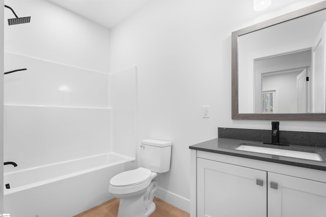 full bathroom with baseboards, toilet, wood finished floors, vanity, and shower / bathing tub combination