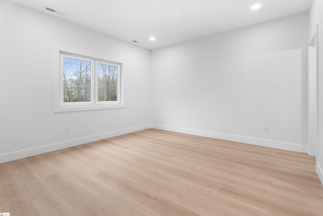 spare room featuring baseboards, recessed lighting, visible vents, and light wood-style floors