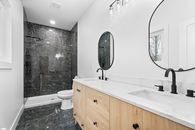 full bath with visible vents, a sink, a marble finish shower, and double vanity