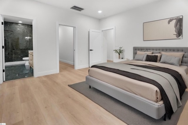 bedroom with visible vents, baseboards, ensuite bath, light wood-style flooring, and recessed lighting