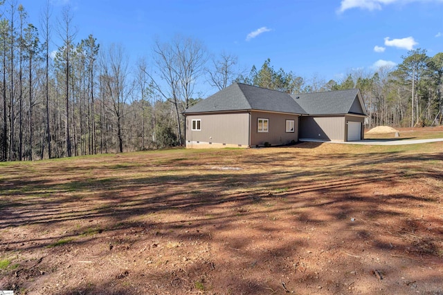 view of property exterior featuring crawl space and an attached garage