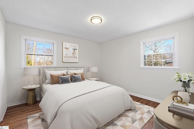 bedroom featuring light wood-style flooring and baseboards