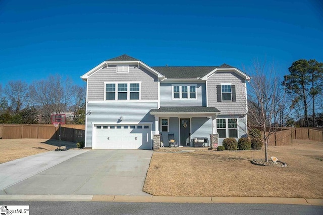 view of front of property with driveway, a front lawn, an attached garage, and fence